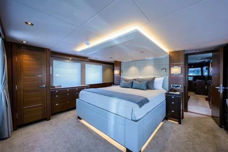 a bedroom with a bed and a desk aboard LACEY KAY Yacht for Sale