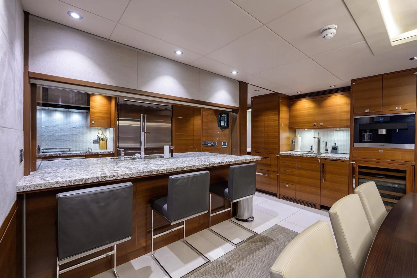 a kitchen with a bar and chairs aboard LACEY KAY Yacht for Sale