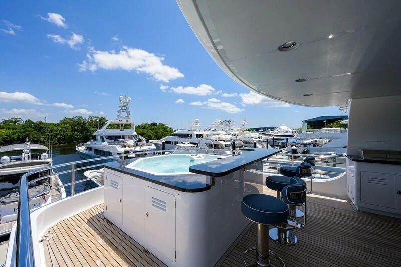 a deck with a deck and a view of a boat and water aboard LACEY KAY Yacht for Sale