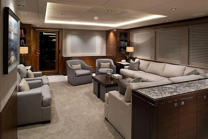 a living room with a large couch and a television aboard LACEY KAY Yacht for Sale