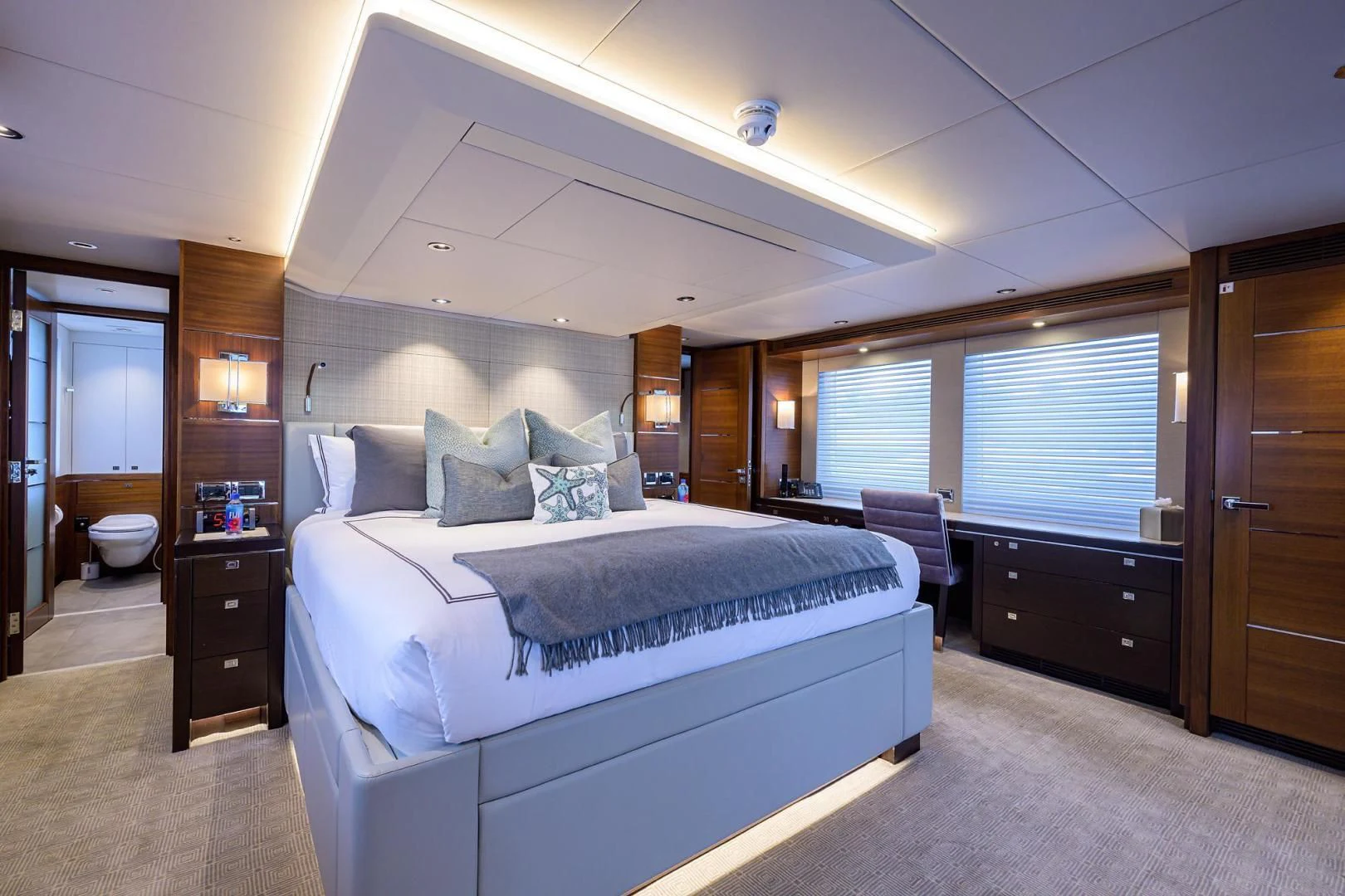a bedroom with a bed and a desk aboard LACEY KAY Yacht for Sale