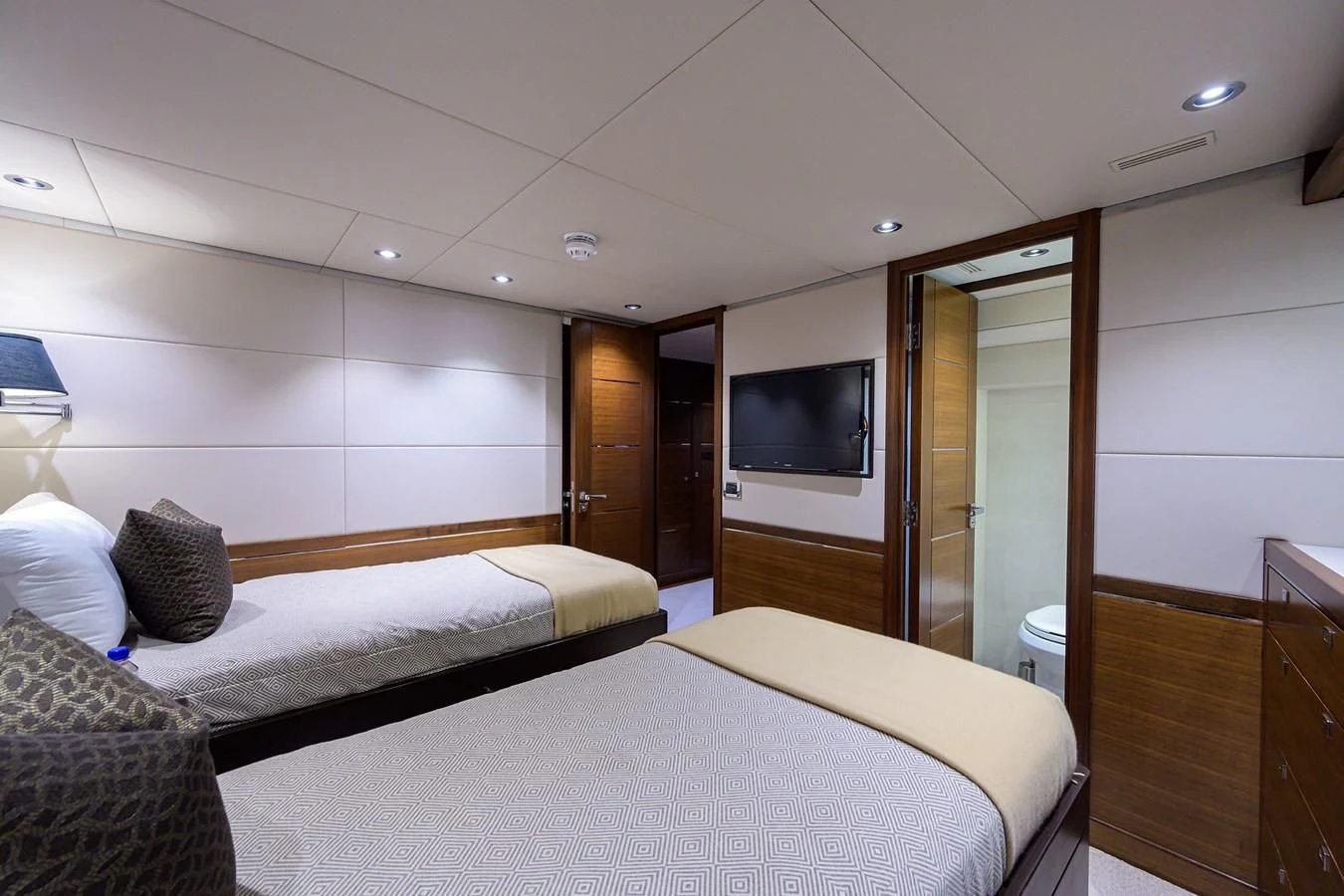 a room with a bed and a television aboard LACEY KAY Yacht for Sale