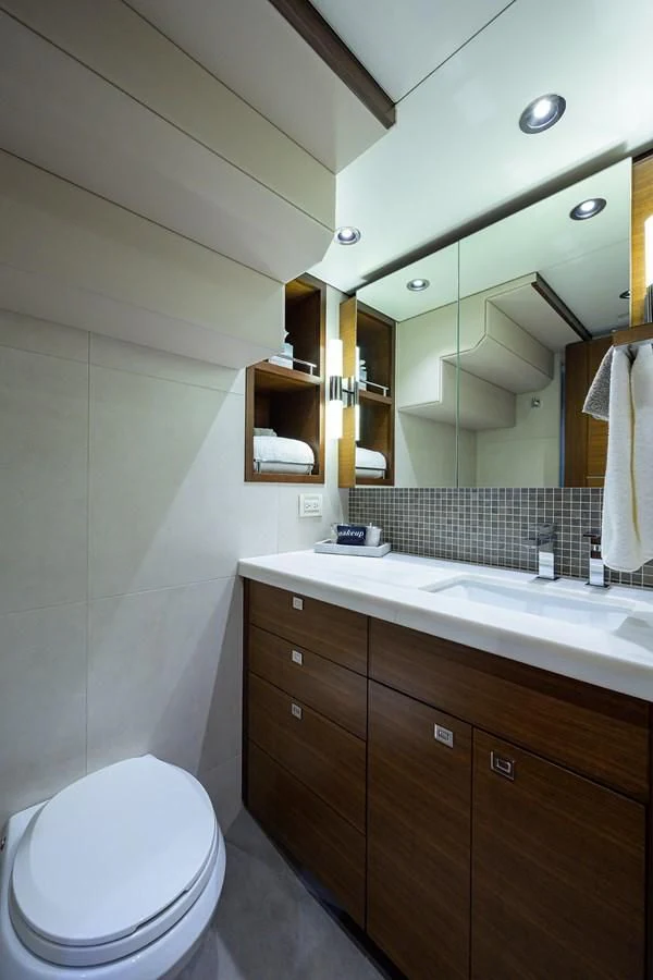 a bathroom with a toilet and a sink aboard LACEY KAY Yacht for Sale