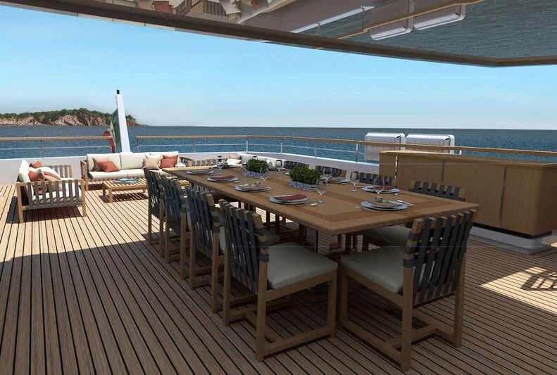 a deck with a table and chairs aboard BOW SPRIT Yacht for Sale