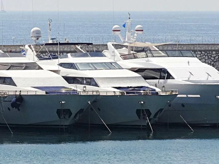 a white yacht in the water aboard OBSESSION Yacht for Sale