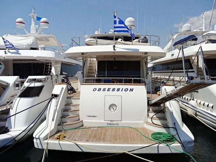 a boat docked at a pier aboard OBSESSION Yacht for Sale