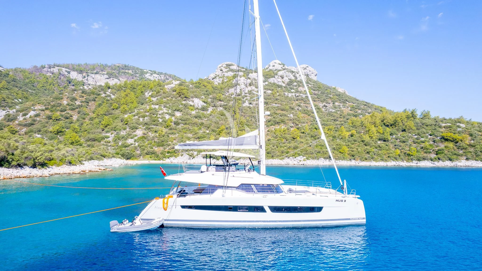a white boat on the water aboard MUS 3 Yacht for Charter