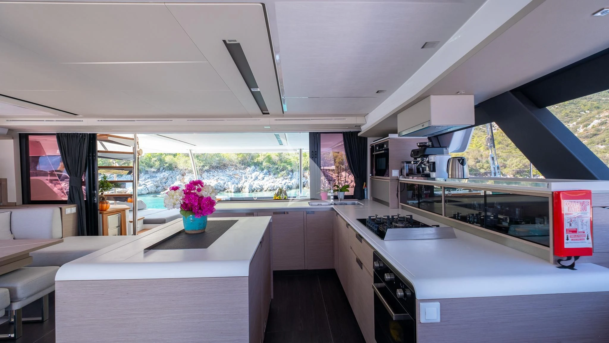 a kitchen with a large window aboard MUS 3 Yacht for Charter