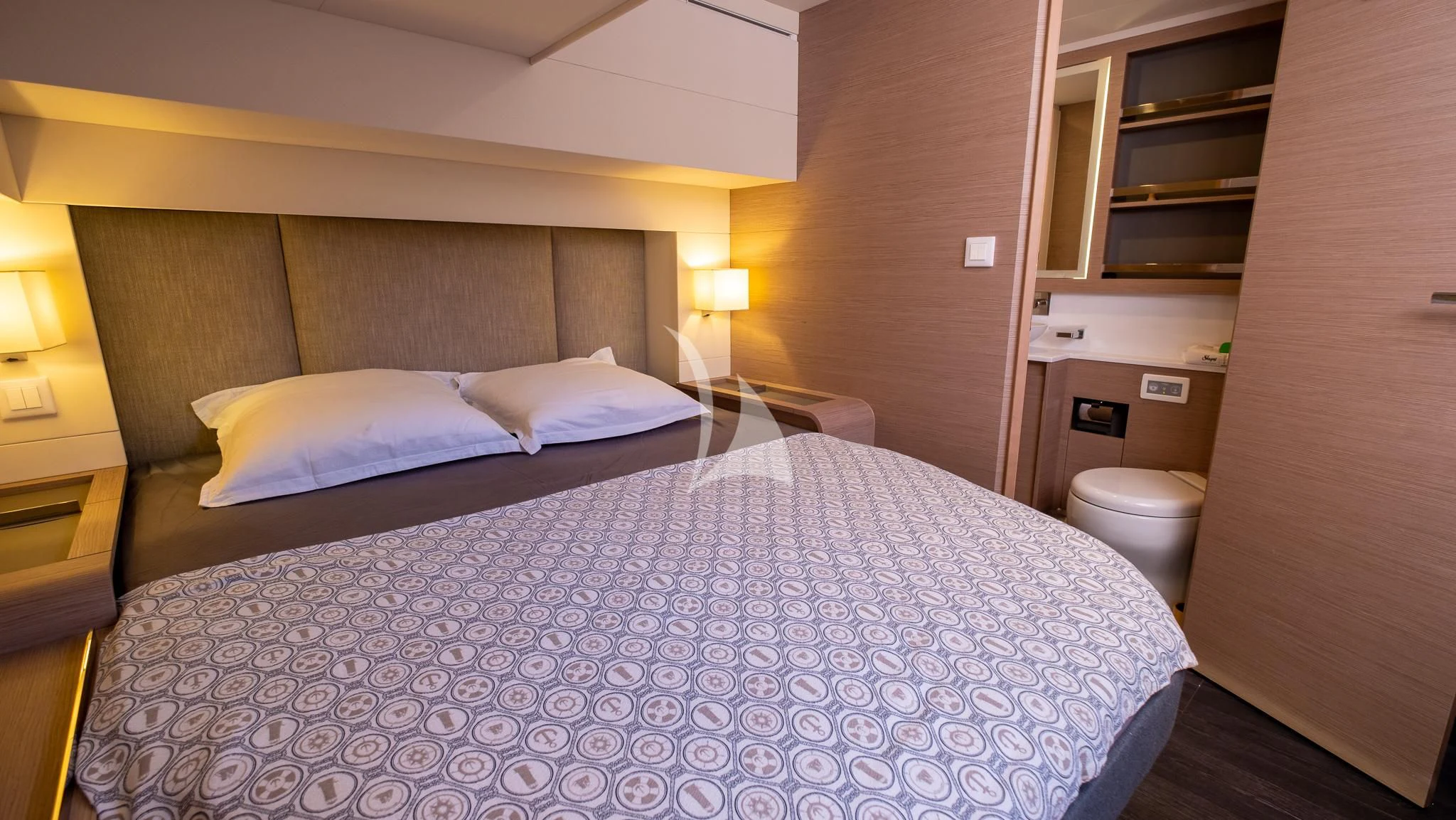 a bed with a white comforter aboard MUS 3 Yacht for Charter