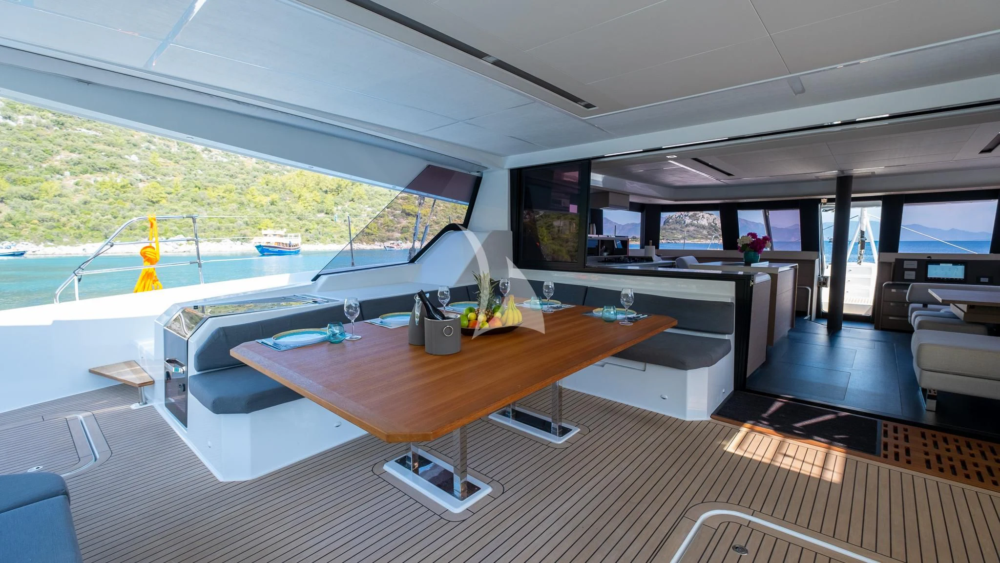 a room with a table and a tv aboard MUS 3 Yacht for Charter