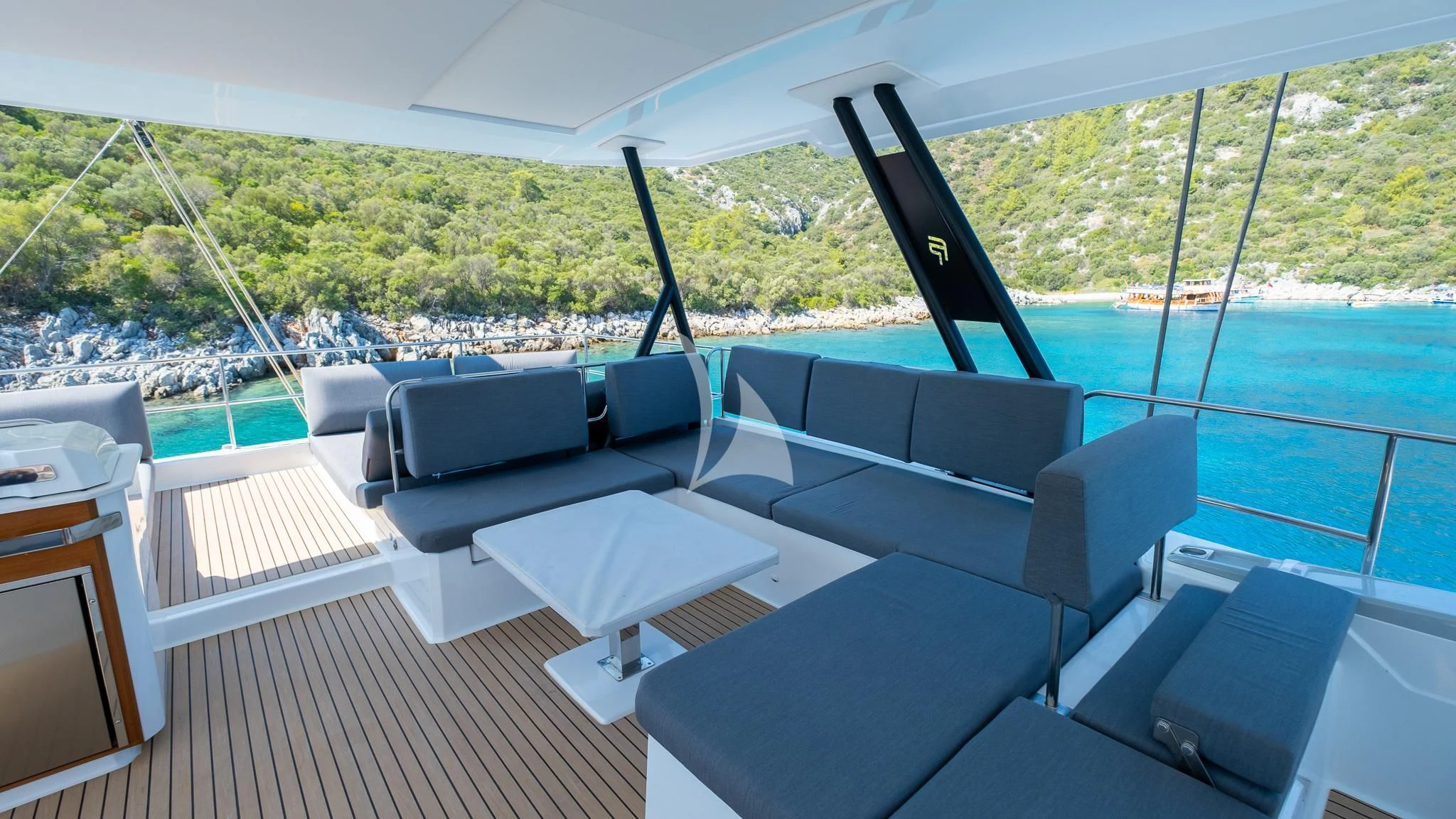 a room with a couch and a table and a pool aboard MUS 3 Yacht for Charter