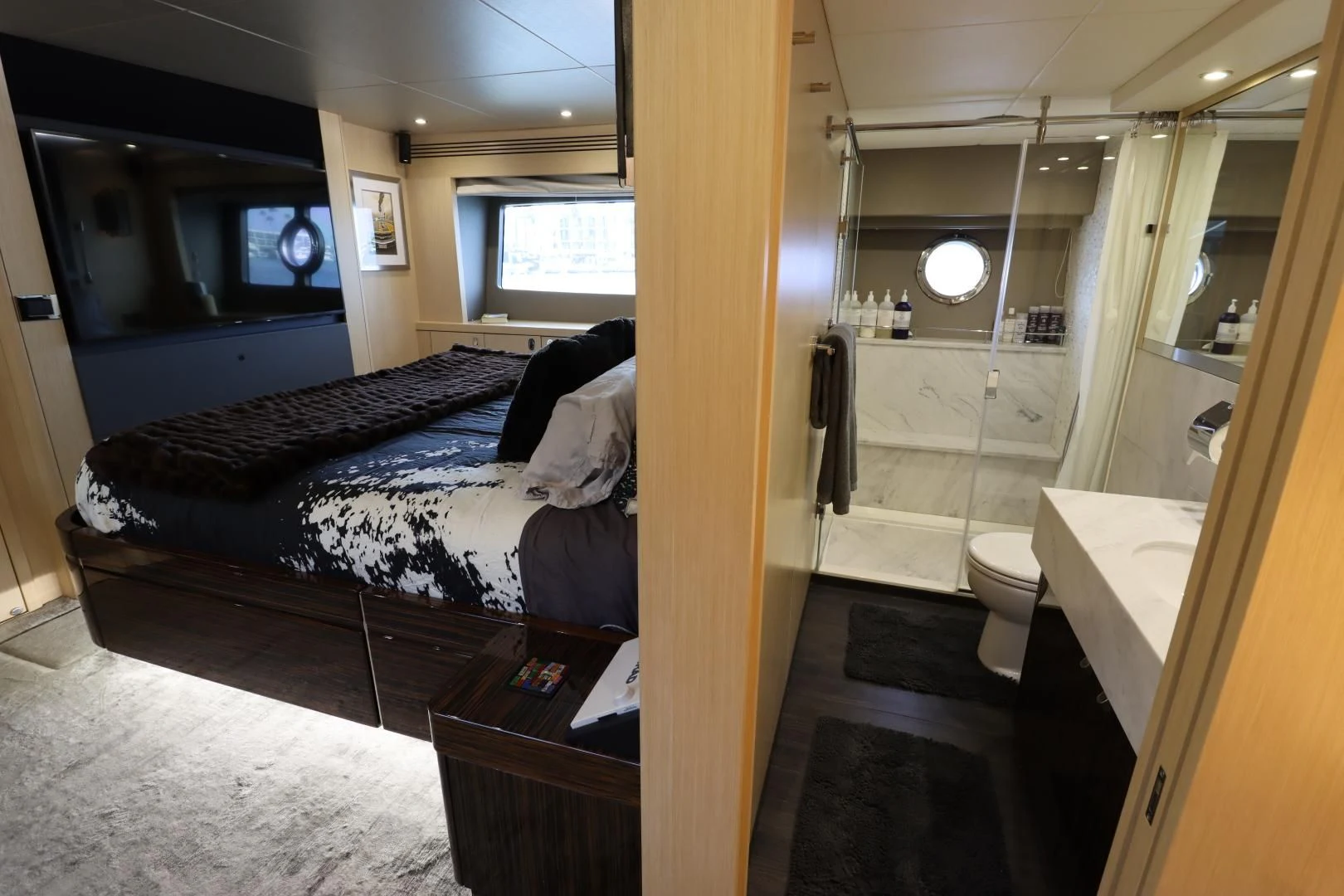 a bedroom with a bed and a mirror aboard MOJO RISIN Yacht for Sale
