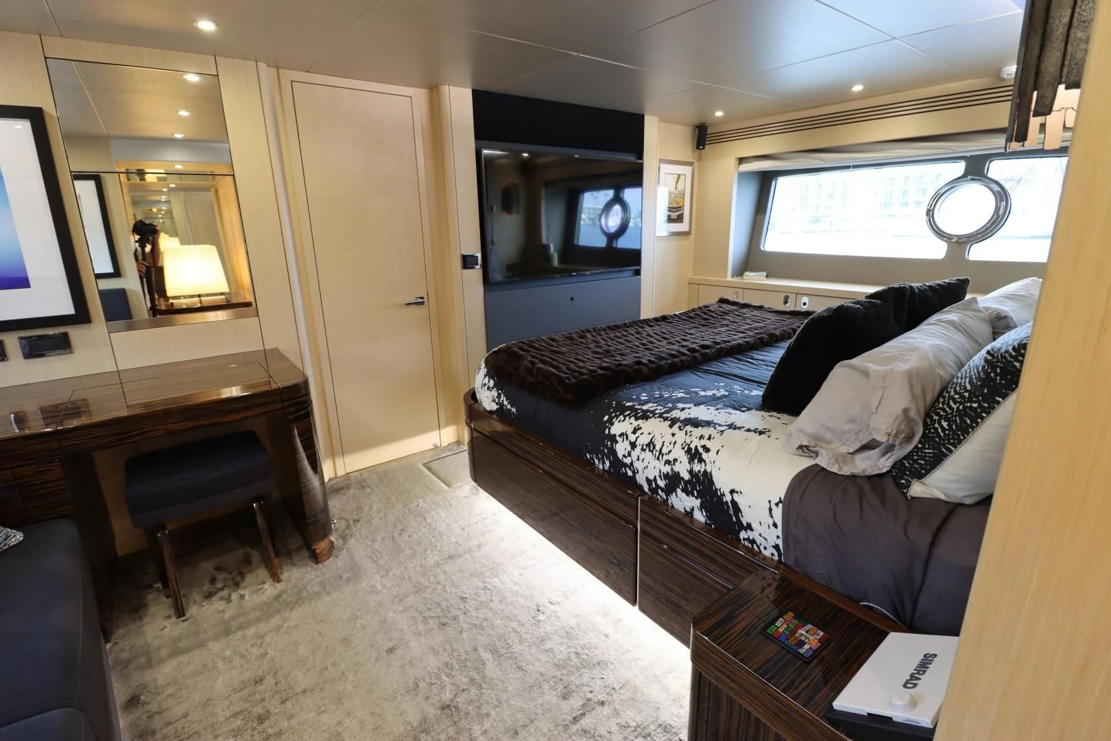 a bedroom with a bed and a tv aboard MOJO RISIN Yacht for Sale