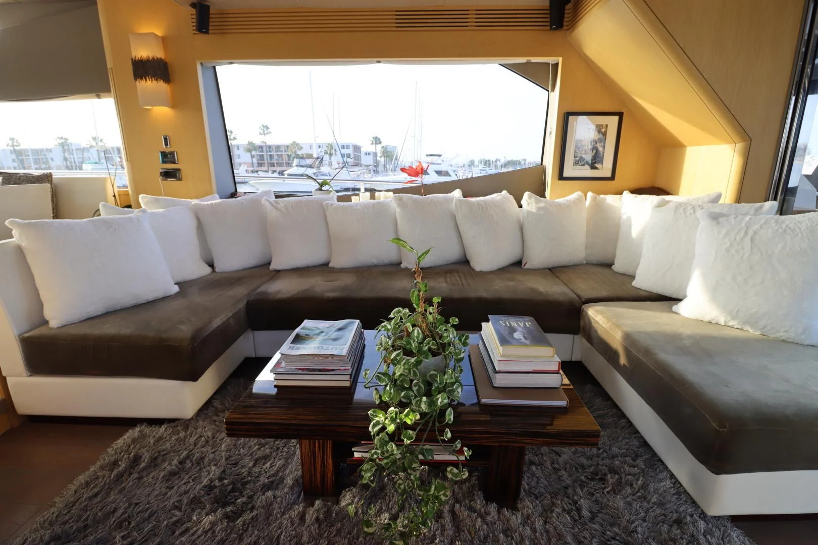 a couch with a coffee table and a large window aboard MOJO RISIN Yacht for Sale