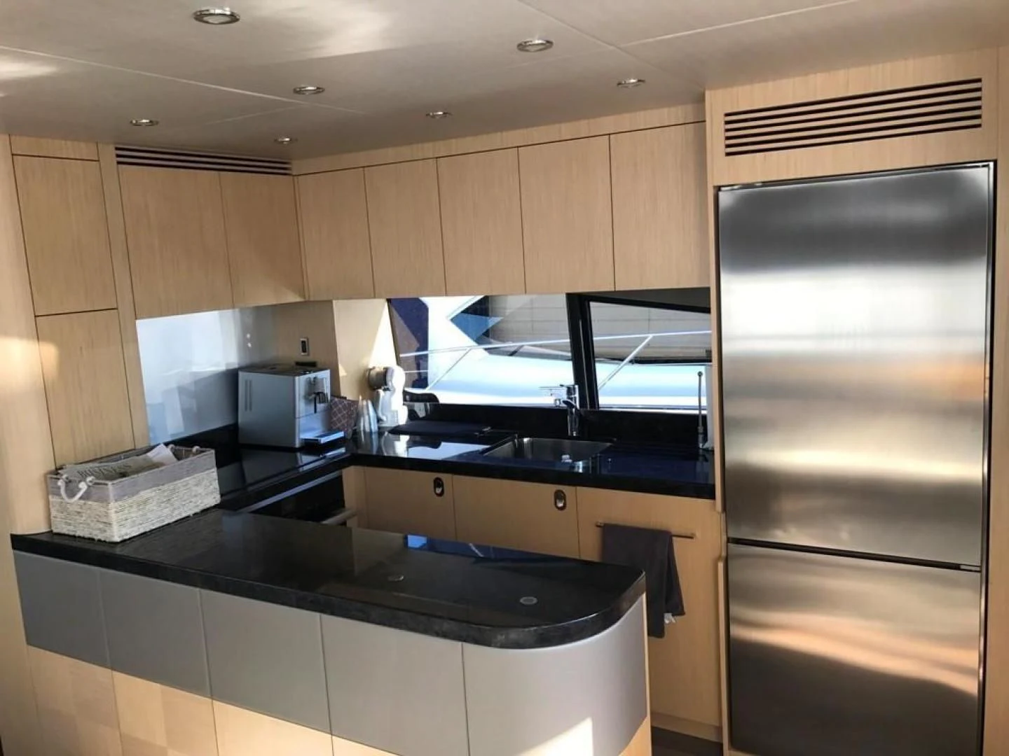 a kitchen with a large refrigerator aboard MOJO RISIN Yacht for Sale