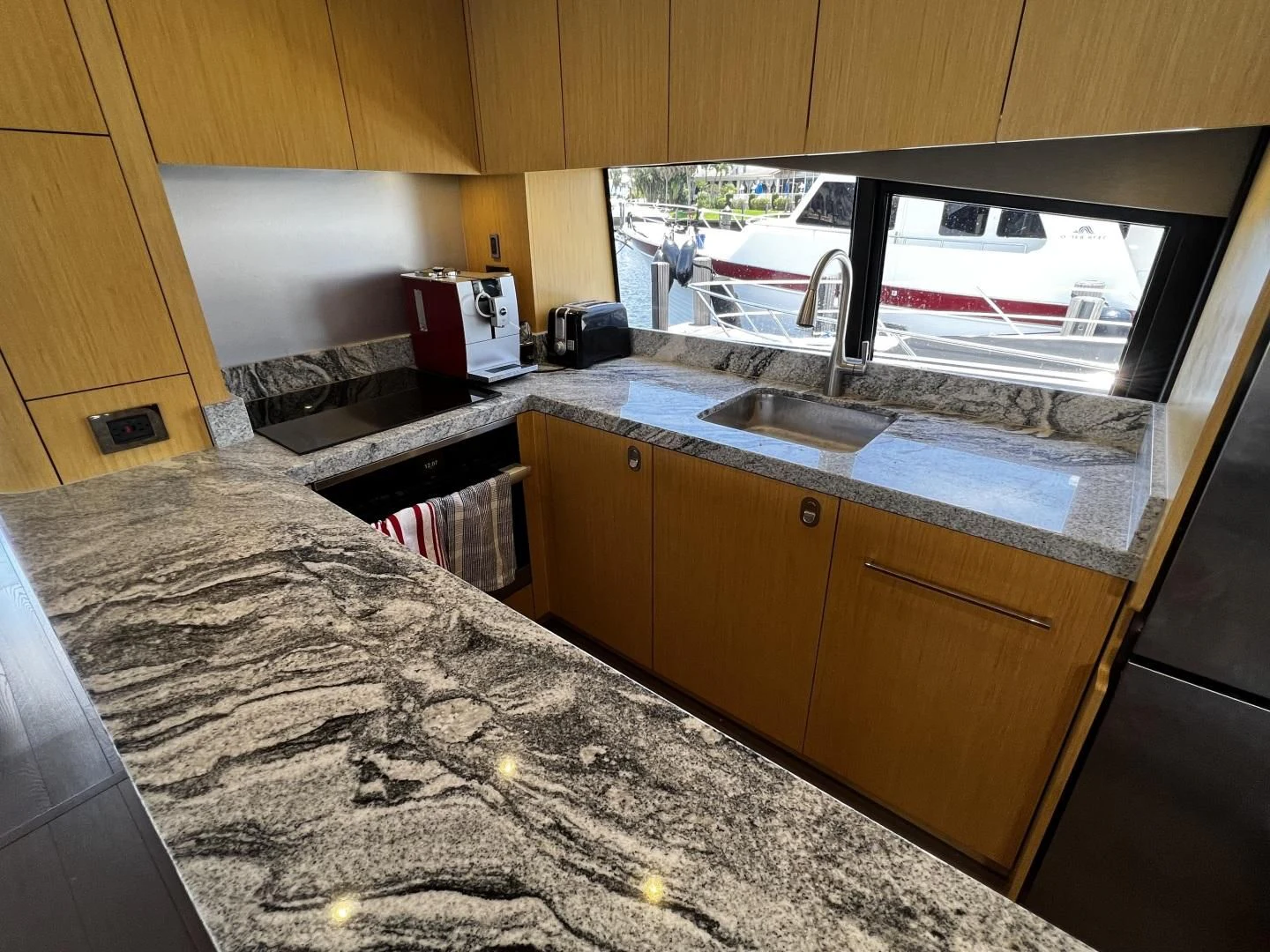 a kitchen with a large marble counter top aboard MOJO RISIN Yacht for Sale