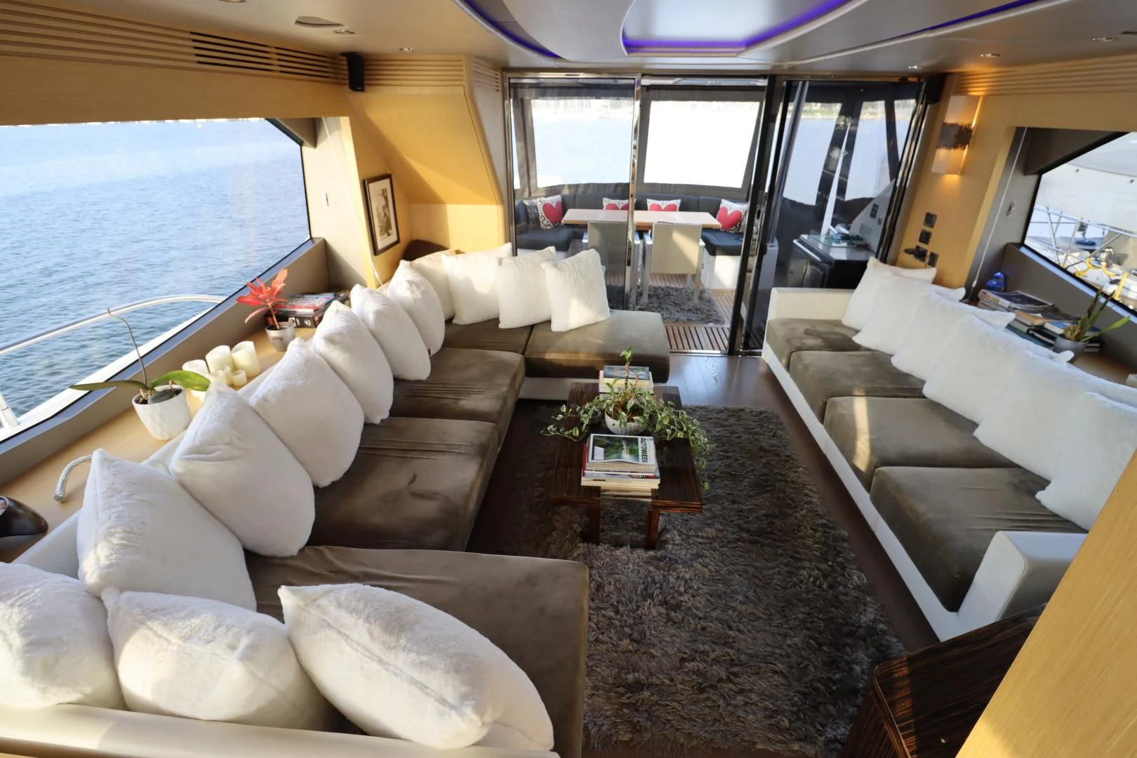 a living room with a large window aboard MOJO RISIN Yacht for Sale