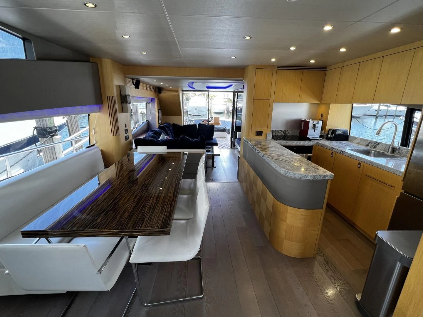 a kitchen with a table and chairs aboard MOJO RISIN Yacht for Sale