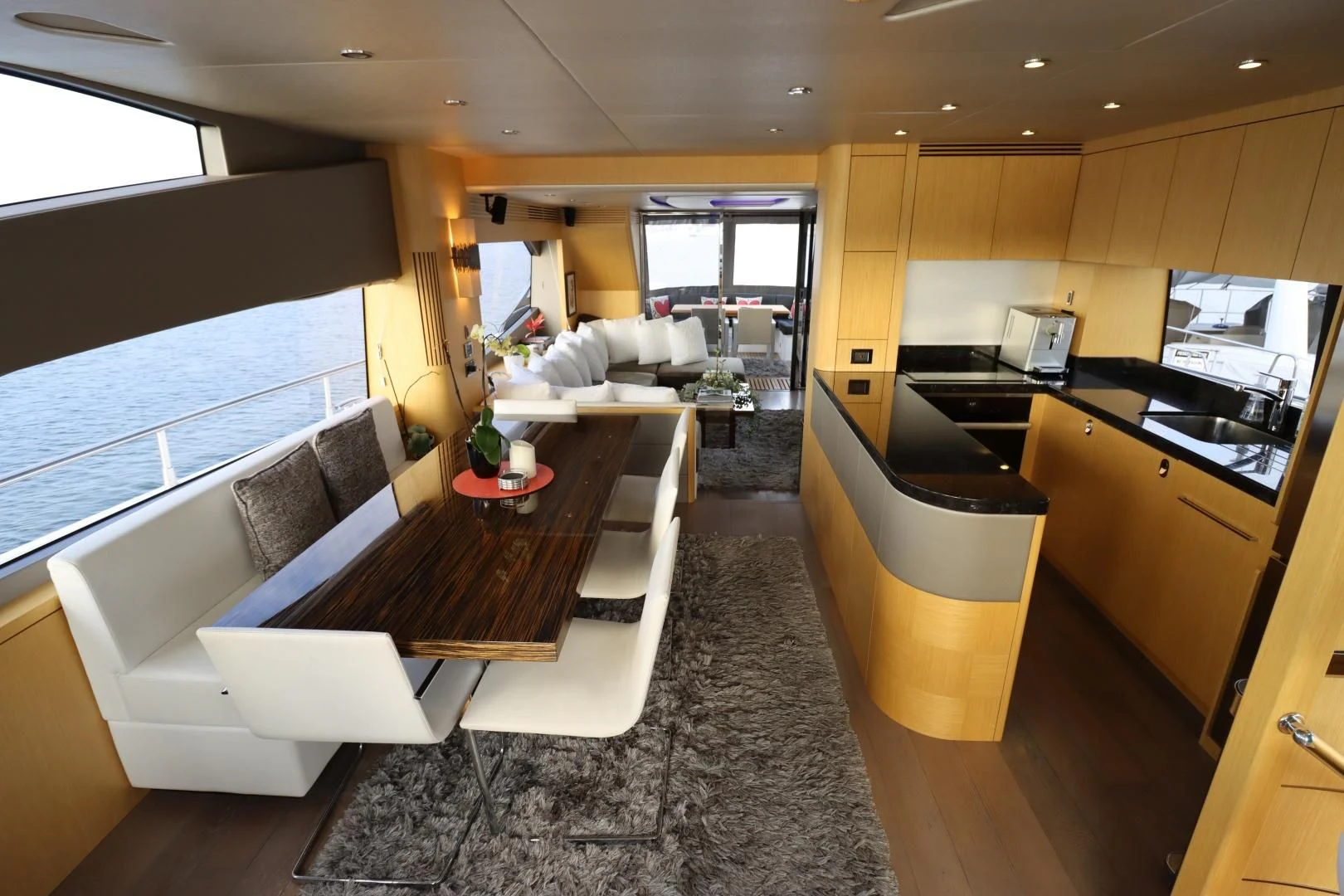 a large kitchen with a table aboard MOJO RISIN Yacht for Sale