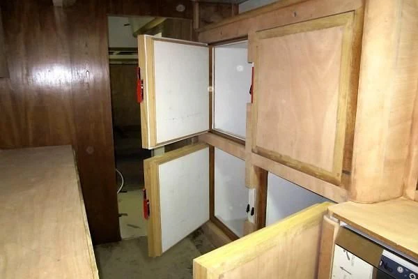 a room with wooden cabinets aboard GARCIA 110 Yacht for Sale