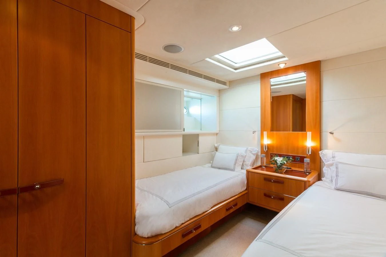a room with a bed and a mirror aboard SWAGGER Yacht for Sale