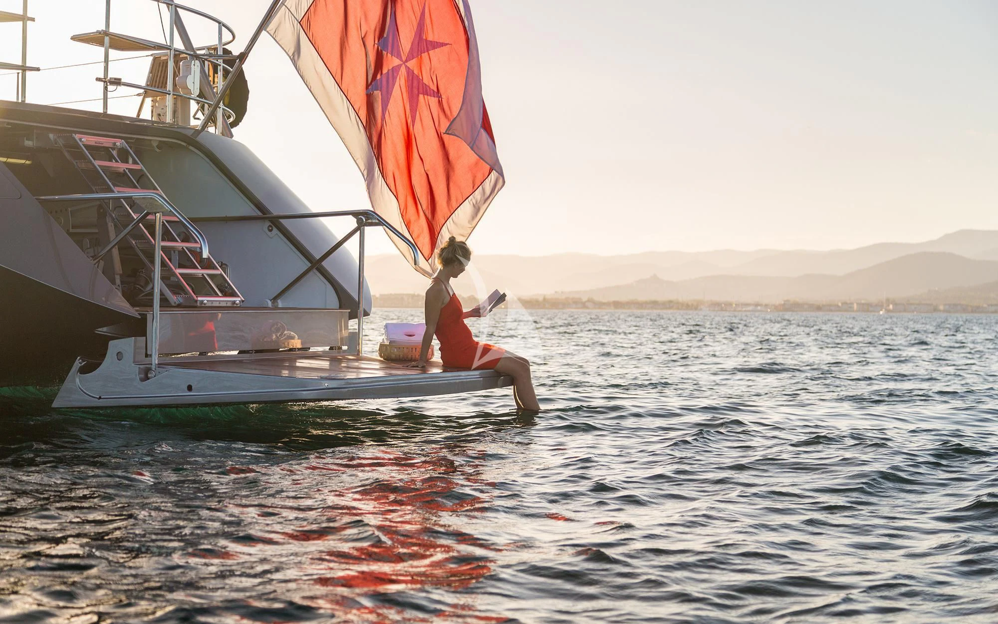 a girl jumping into the water aboard SWAGGER Yacht for Sale