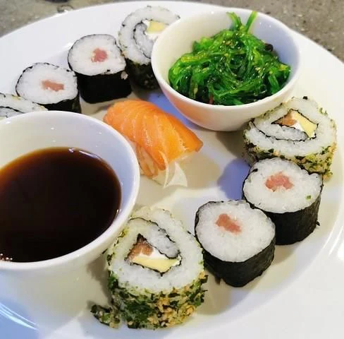 a plate of sushi and a cup of sauce aboard SWAGGER Yacht for Sale