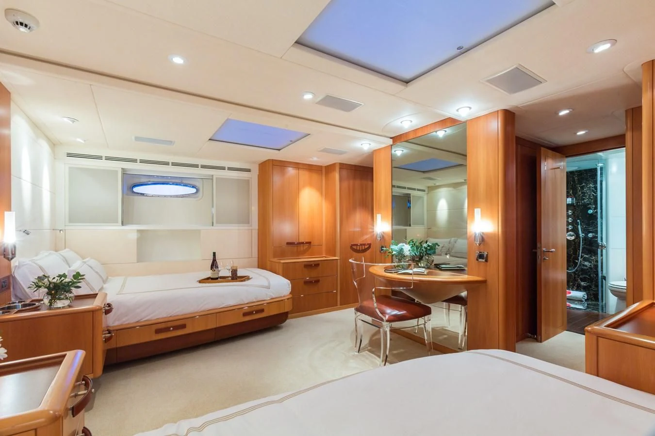 a bedroom with a bed and a desk aboard SWAGGER Yacht for Sale