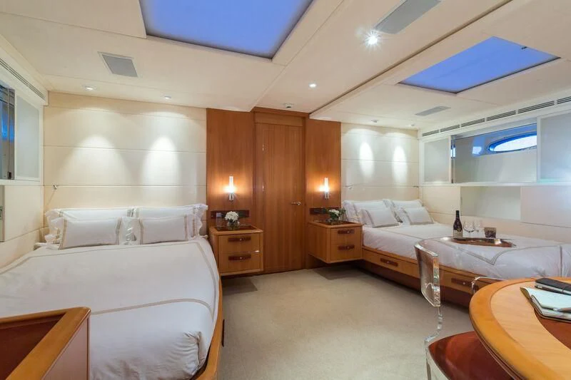 a room with a bed and a table aboard SWAGGER Yacht for Sale