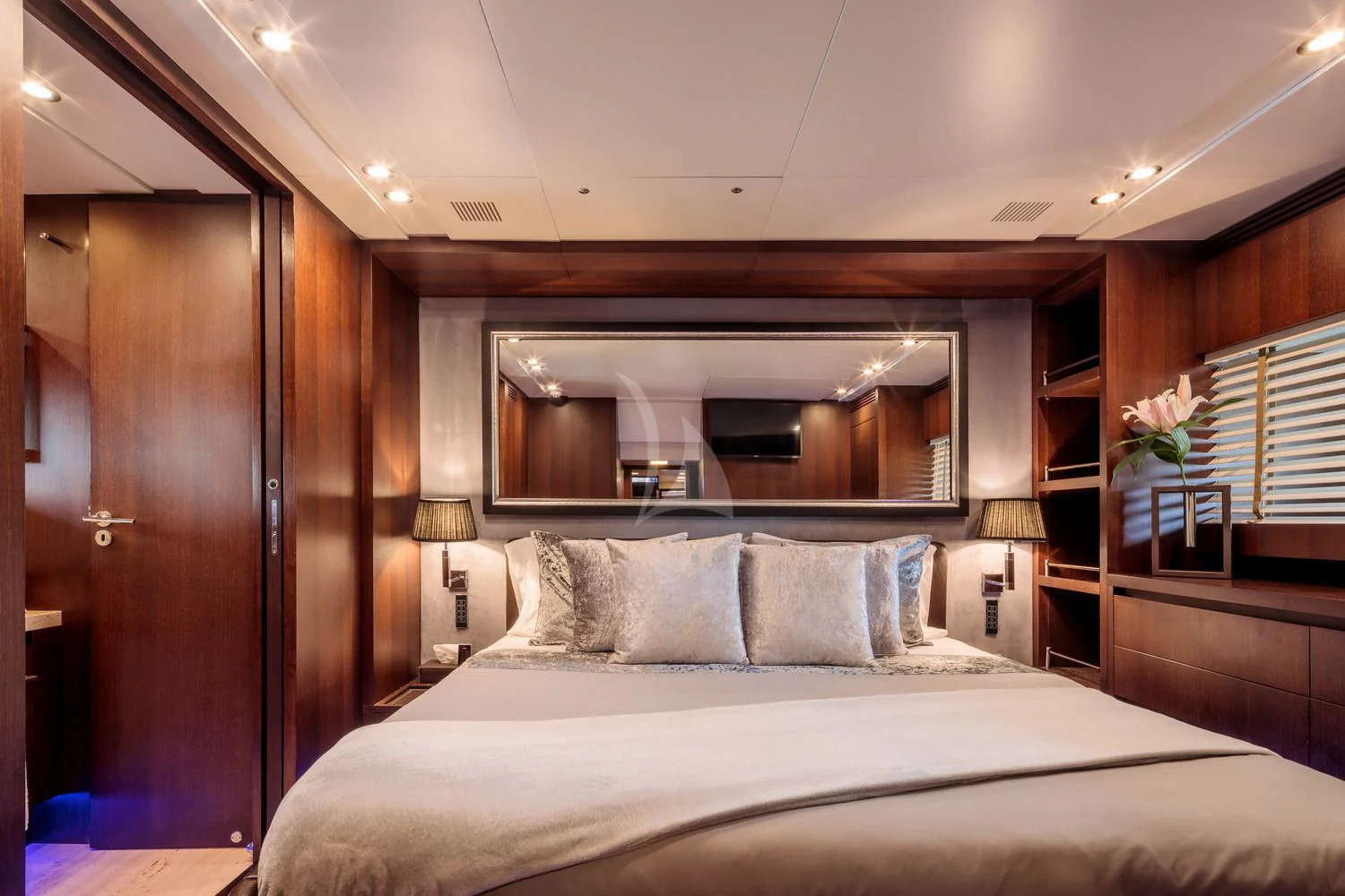 a bed with a white bed spread aboard MIRAVAL Yacht for Charter