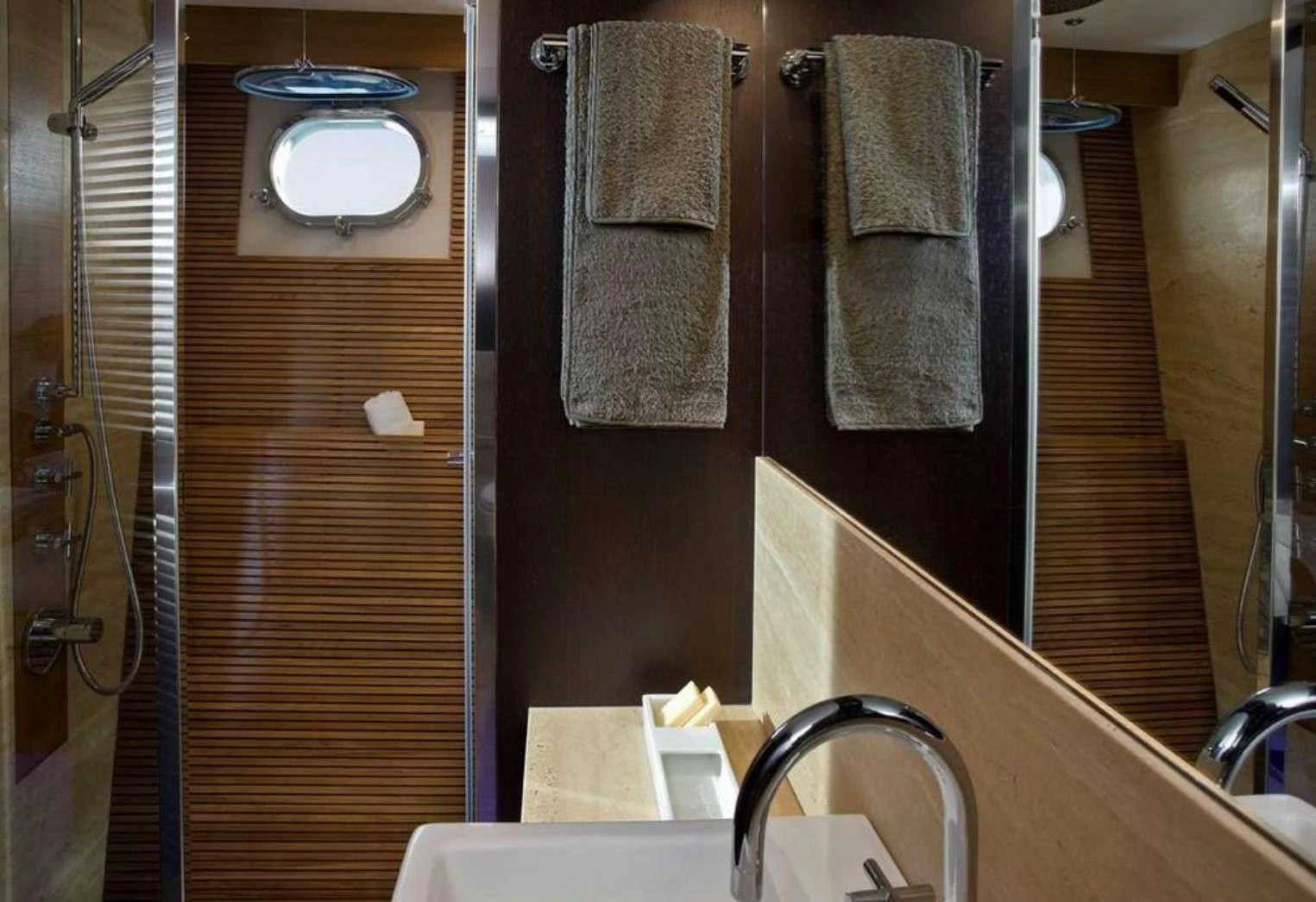 a bathroom with a sink and towels aboard MIRAVAL Yacht for Charter