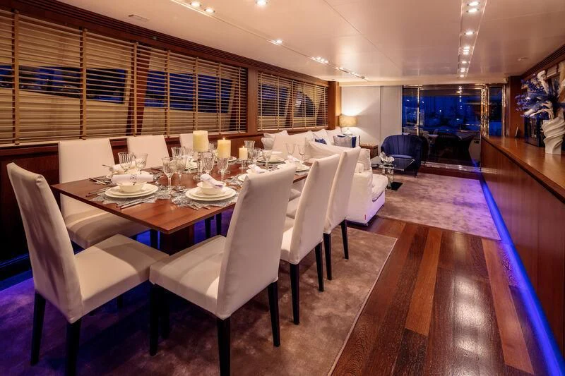 a dining room with a table and chairs aboard MIRAVAL Yacht for Charter