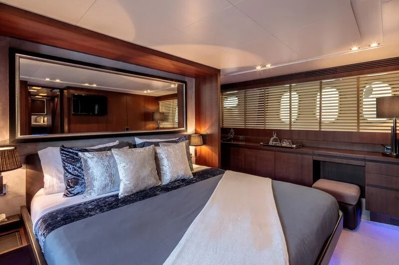 a bed with pillows and a mirror aboard MIRAVAL Yacht for Charter