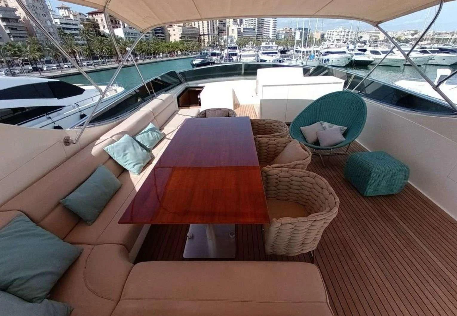 a deck with a view of boats and a city aboard MIRAVAL Yacht for Charter