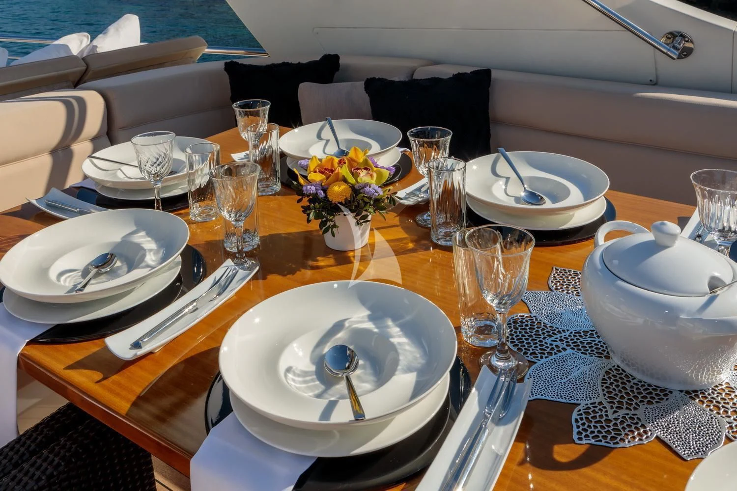 a table with plates and glasses aboard MIRAVAL Yacht for Charter