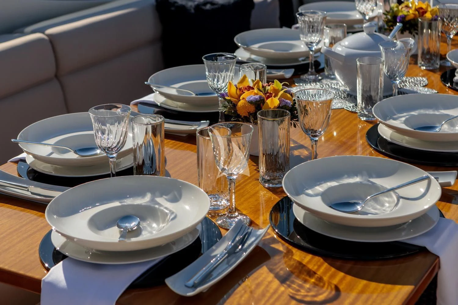 a table set with plates and glasses aboard MIRAVAL Yacht for Charter