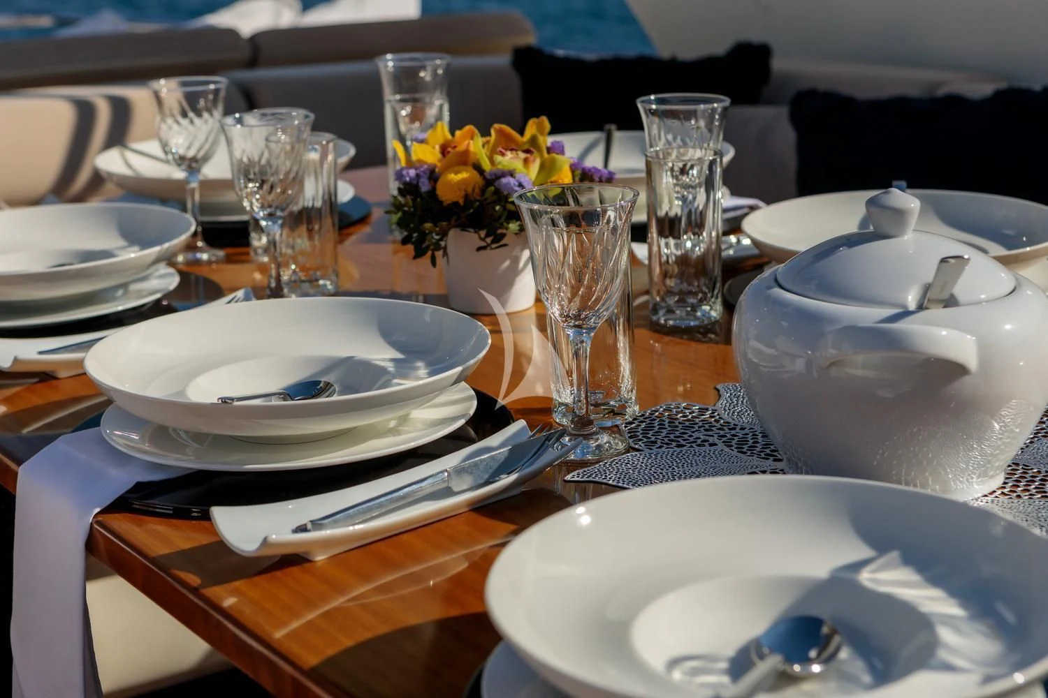 a table with plates and glasses aboard MIRAVAL Yacht for Charter