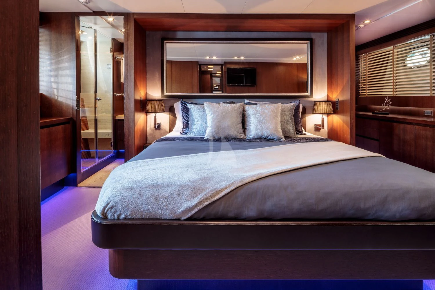 a bed with a blue sheet aboard MIRAVAL Yacht for Charter