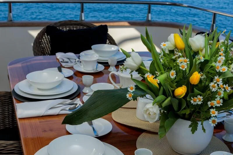 a table with plates and cups aboard MIRAVAL Yacht for Charter