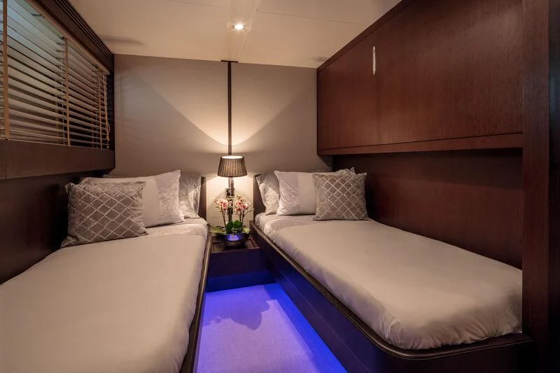 a room with a bed and a table aboard MIRAVAL Yacht for Charter