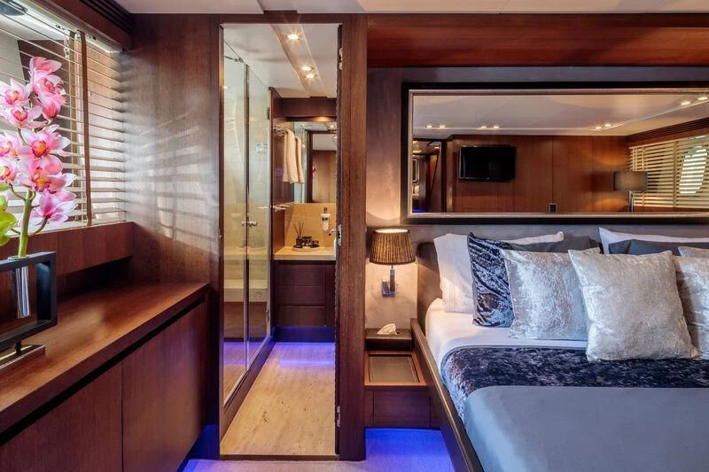 a bedroom with a bed and a mirror aboard MIRAVAL Yacht for Charter