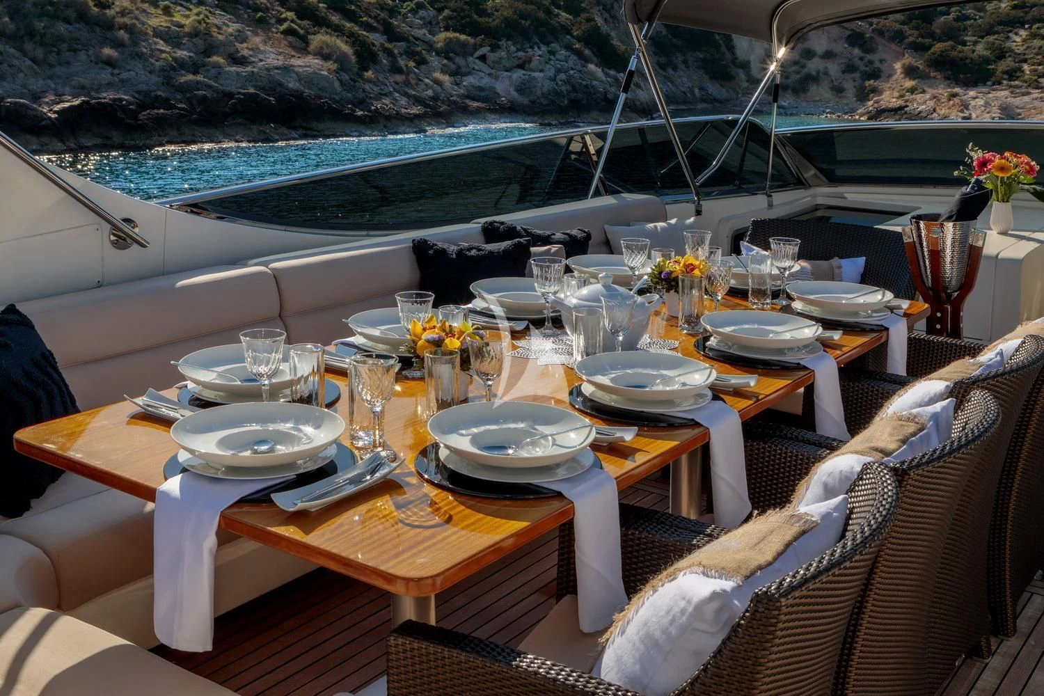 a table set for a dinner on a boat aboard MIRAVAL Yacht for Charter