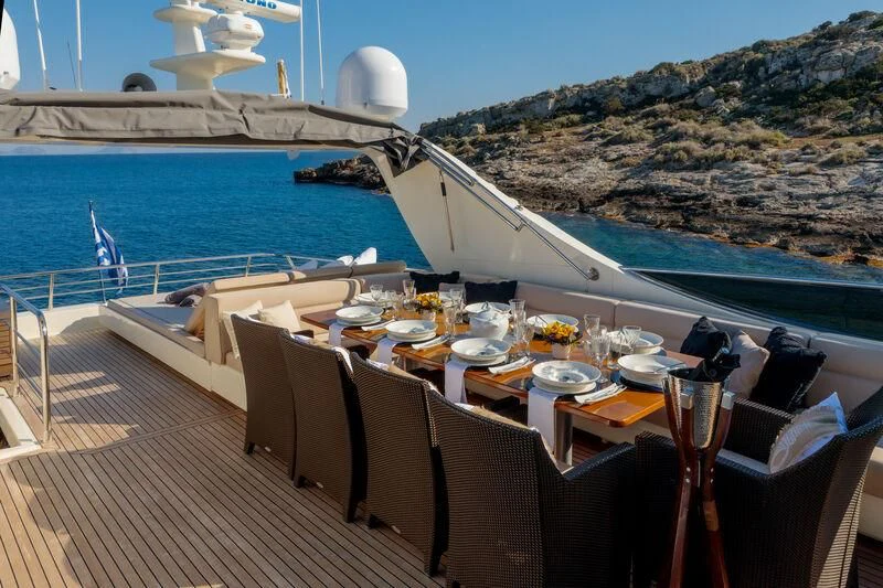a table set for a meal on a boat aboard MIRAVAL Yacht for Charter