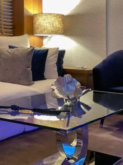 a bed with a blue blanket aboard MIRAVAL Yacht for Charter