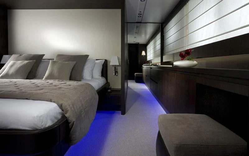 a room with a bed and a desk aboard MIRAVAL Yacht for Charter