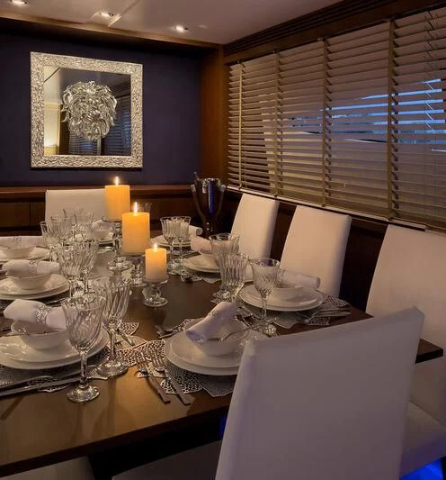 a table with plates and glasses aboard MIRAVAL Yacht for Charter