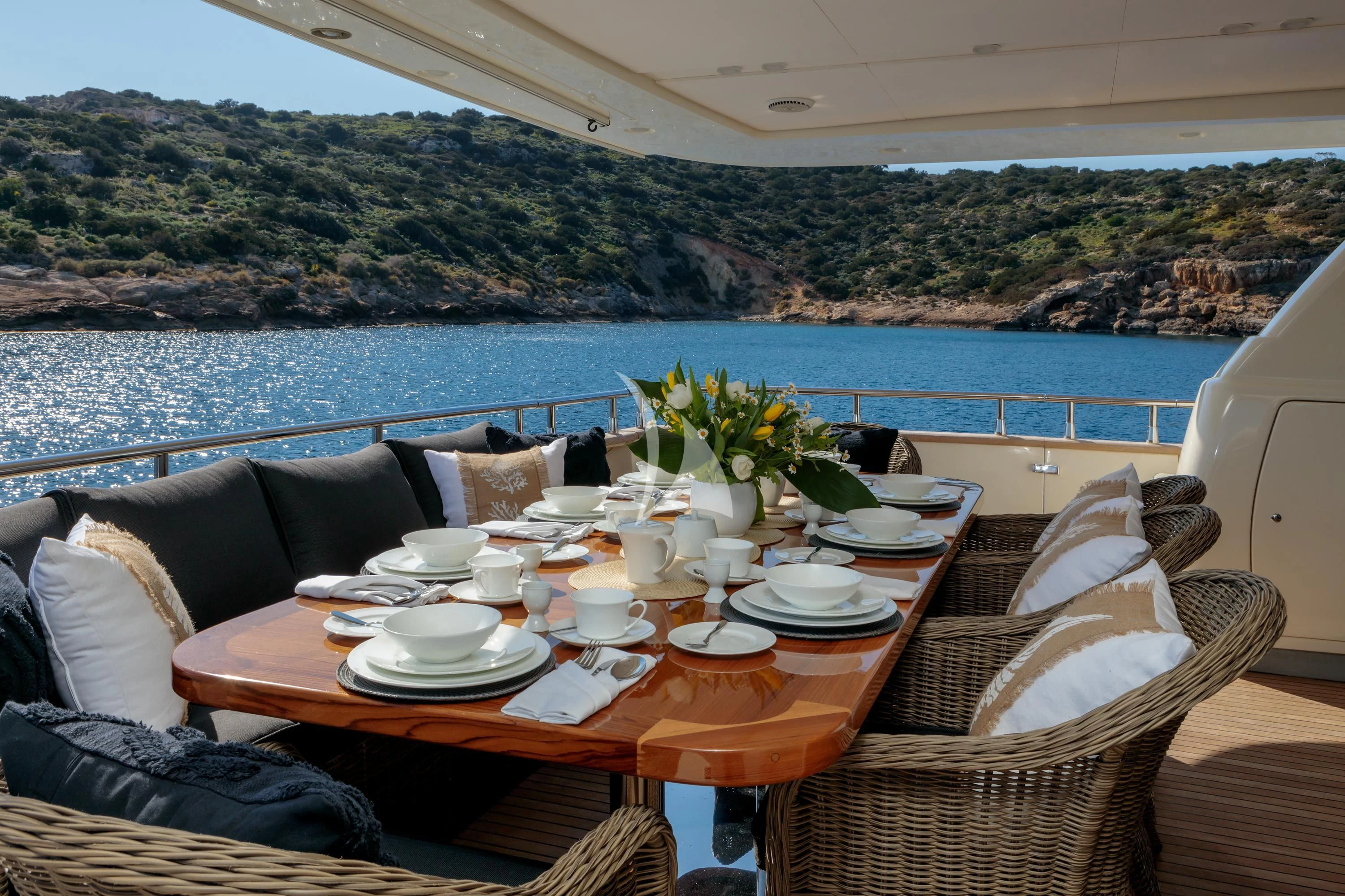 a table with plates and cups on it aboard MIRAVAL Yacht for Charter