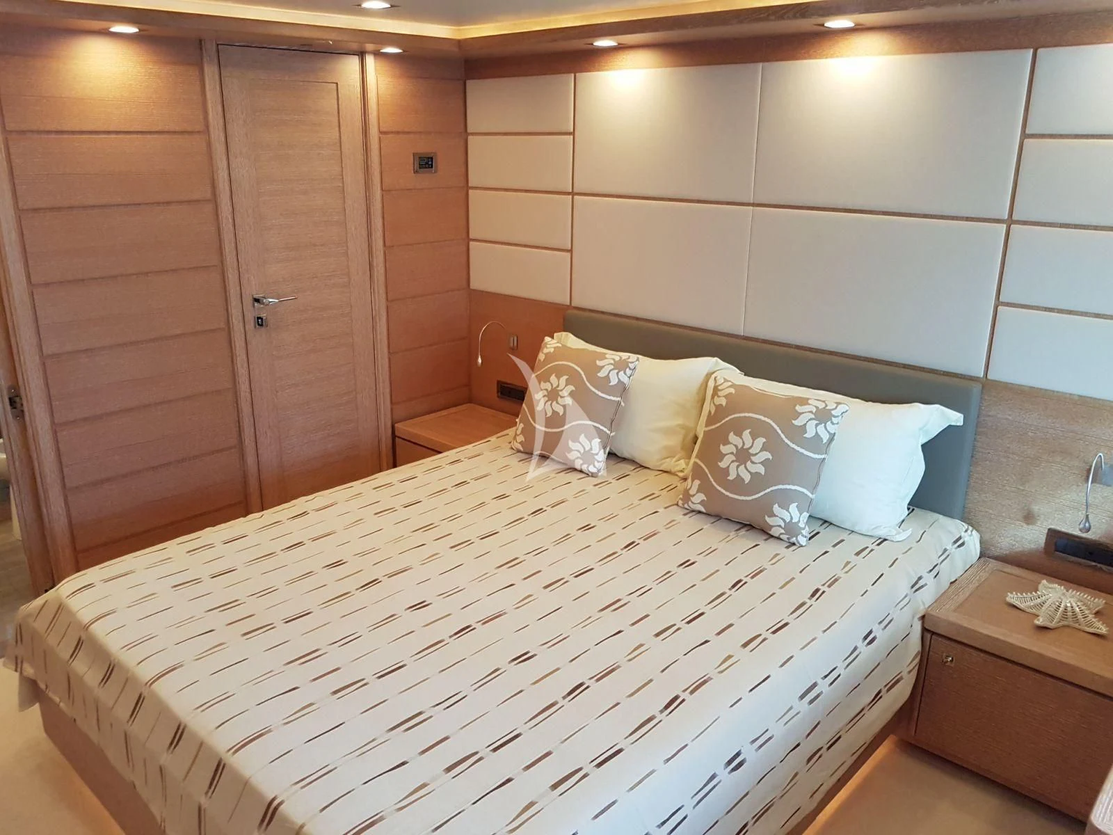 a bed with white sheets and pillows aboard ACCEPTUS Yacht for Sale