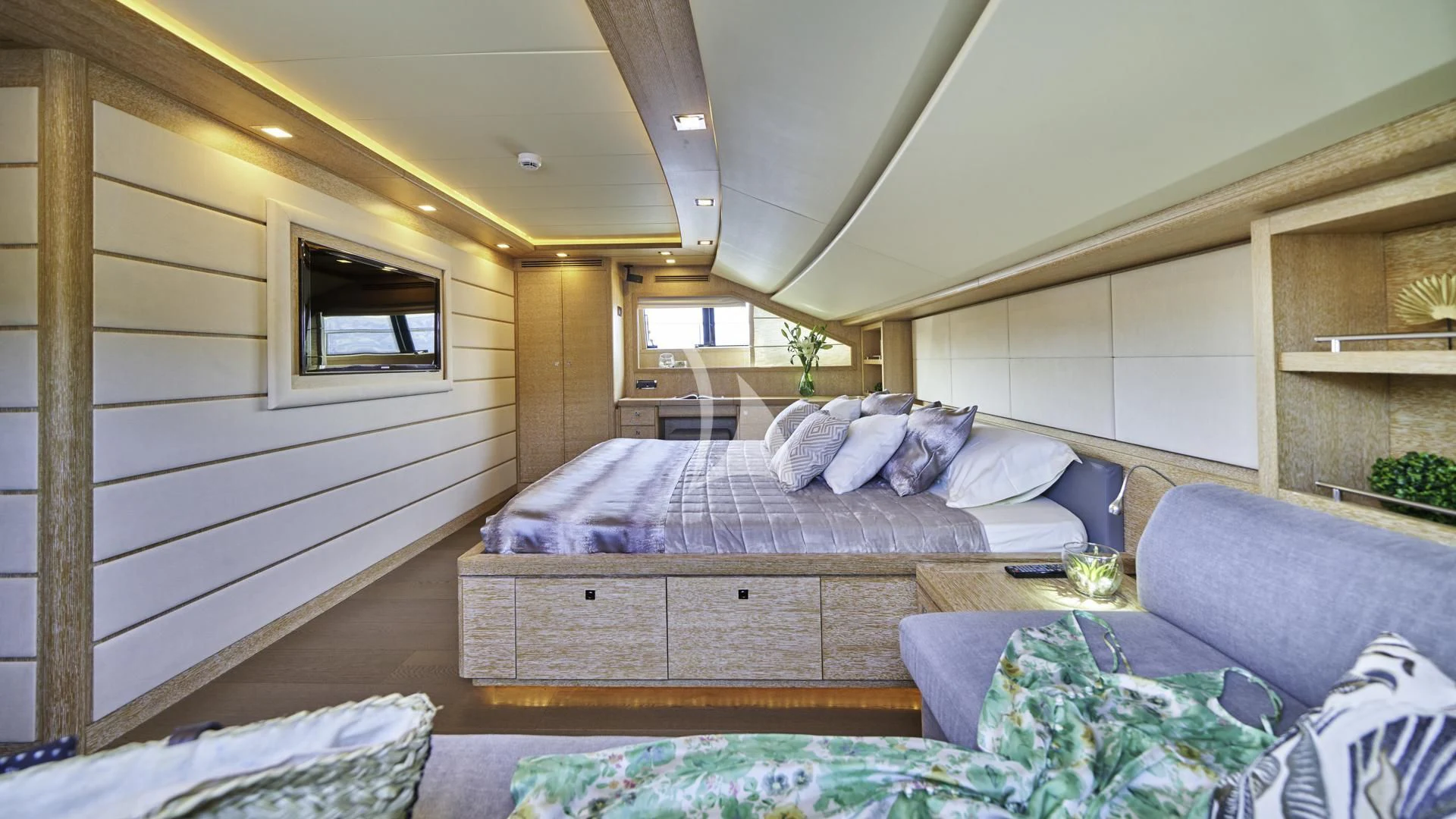 a bedroom with a bed and a couch aboard ACCEPTUS Yacht for Sale