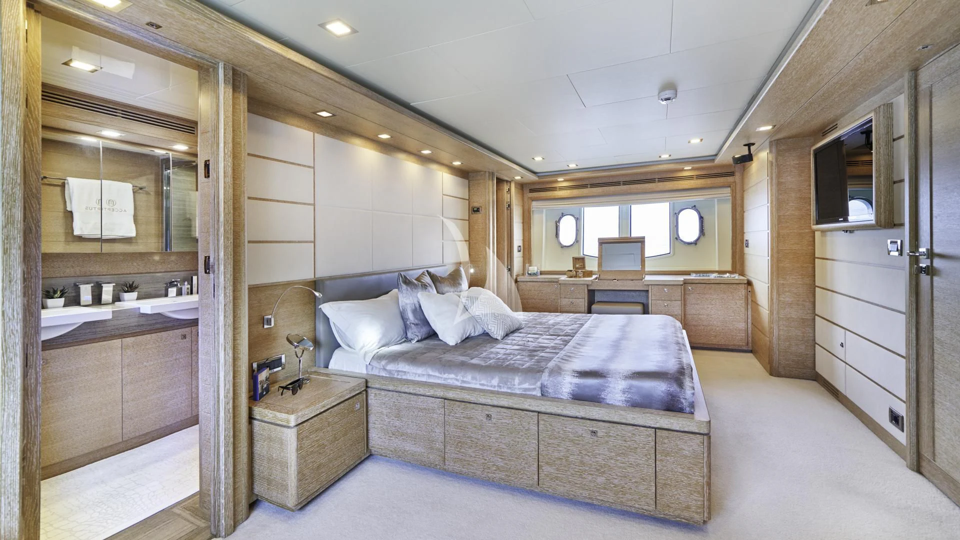 a bedroom with a bed and a mirror aboard ACCEPTUS Yacht for Sale